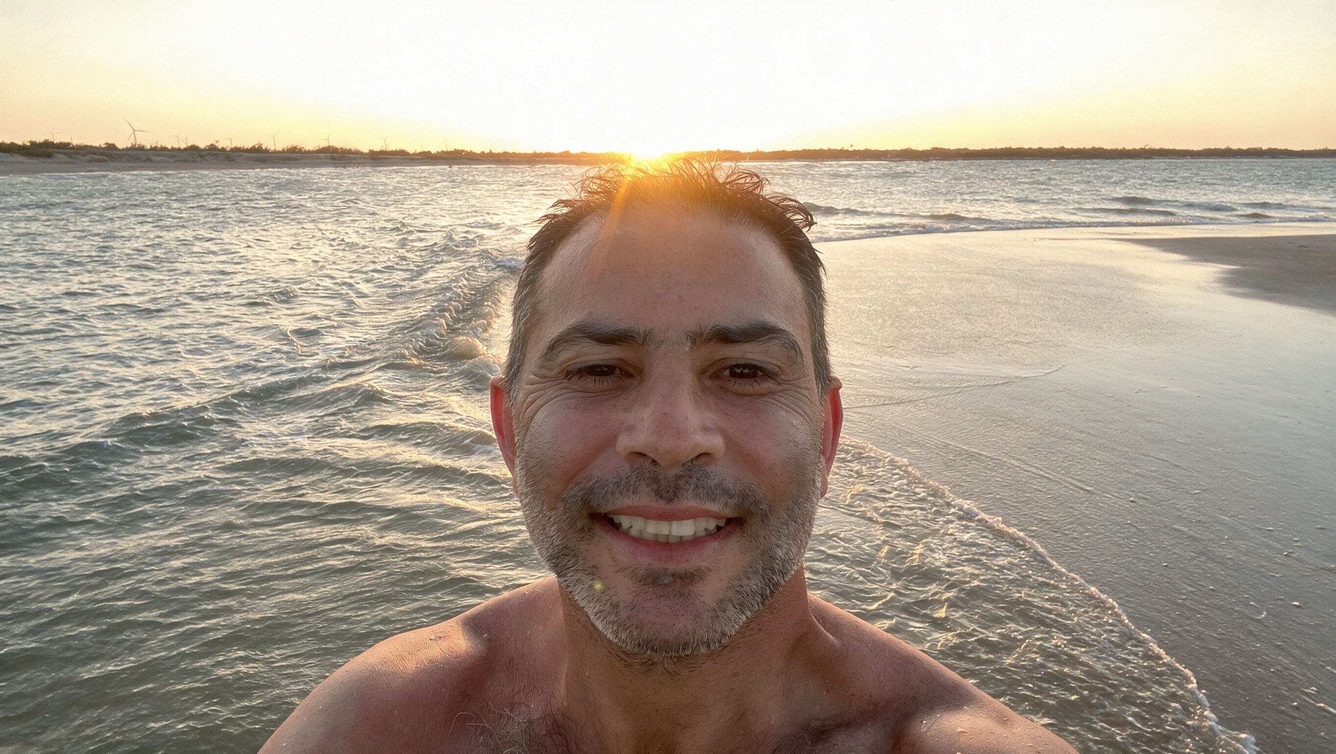 André Tal on the beach André Tal on the beach at sunset, smiling into the camera